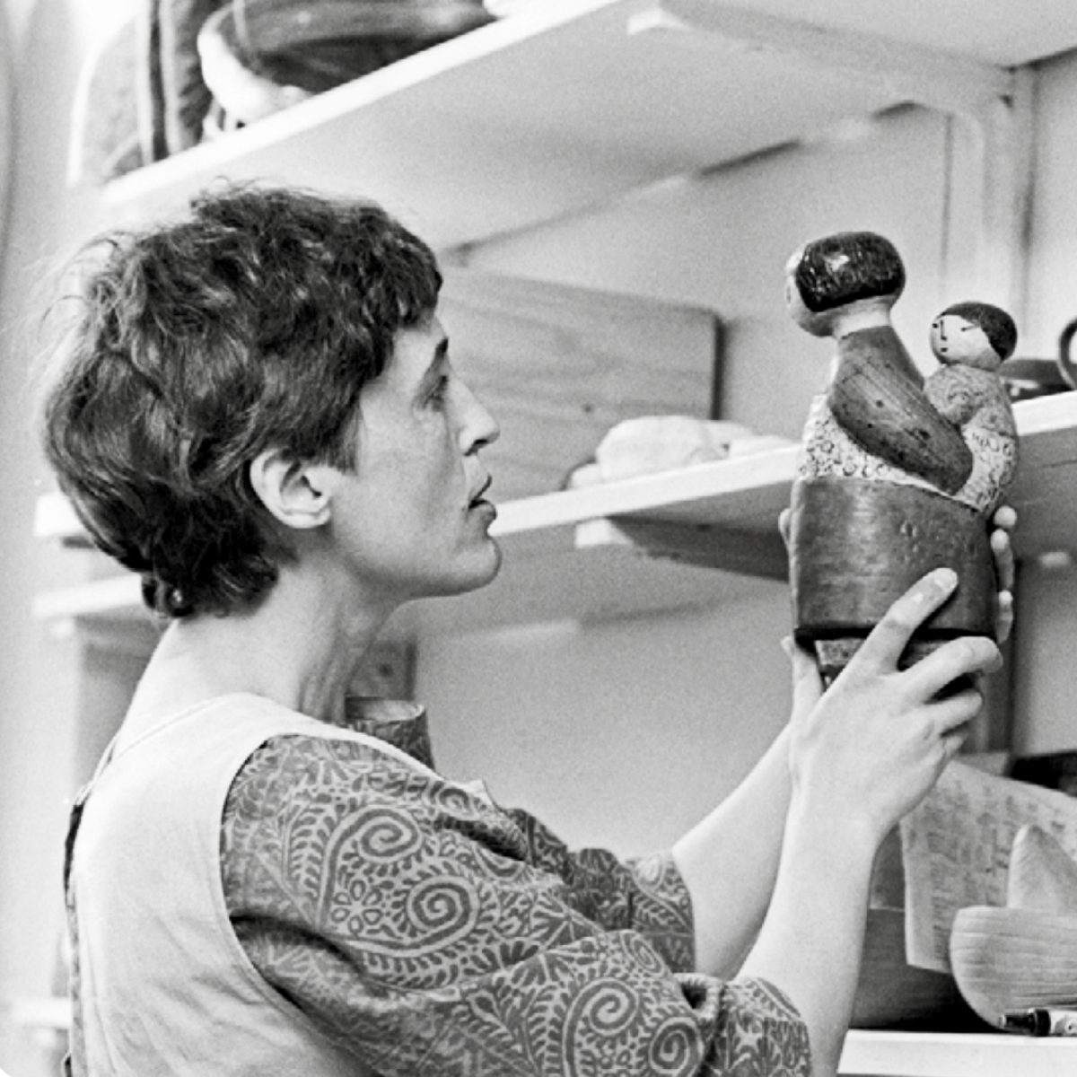 Lisa Larson inspecting the figurine Japanese woman